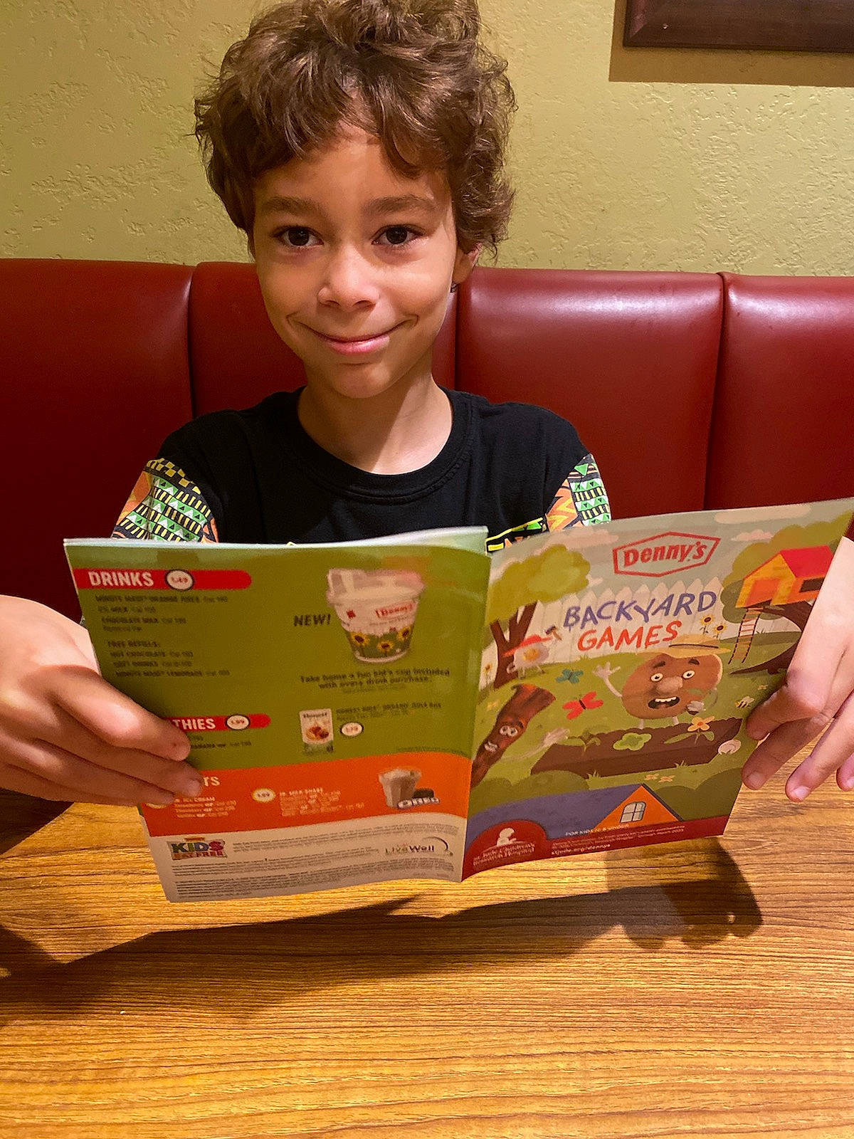 Denver joined the competition — help win amazing prizes! adaptation, book, child, couch, education, face, fun, hand, happy, head, joy, learning, person, publication, reading, room, sharing, sitting, smile, t_shirt