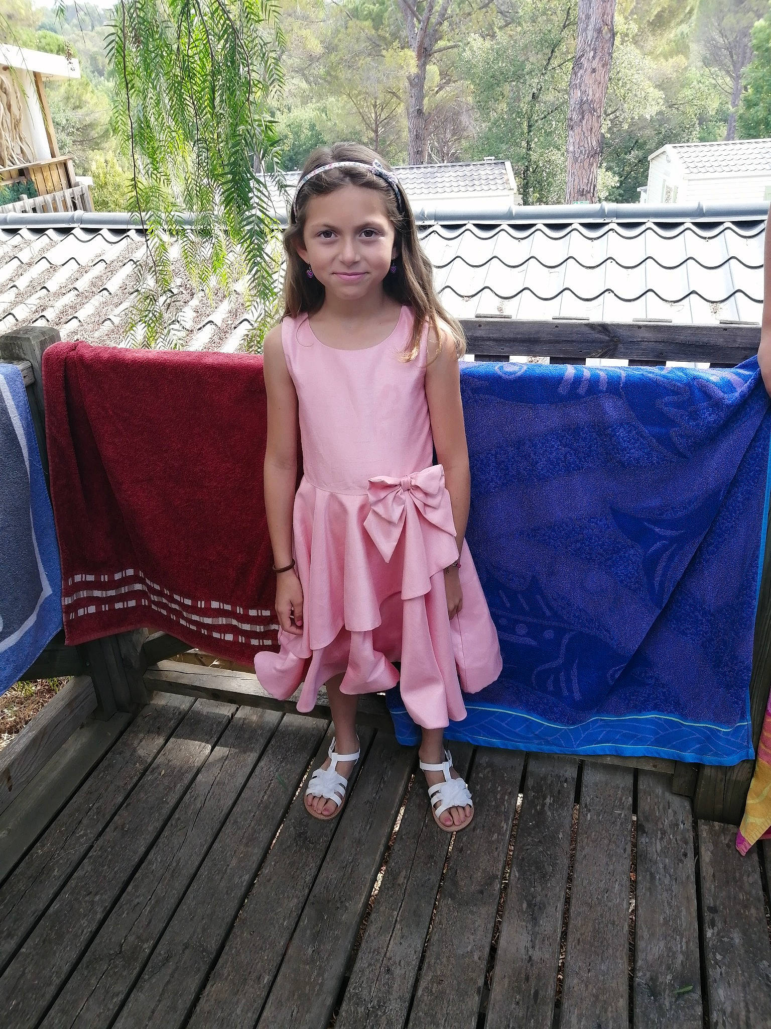 Maelia a rejoint le concours — aidez-le/la à gagner de superbes lots ! child, dress, event, fashion_accessory, fun, garden, grass, happy, joy, leisure, magenta, outdoor_furniture, pattern, person, plant, recreation, sandal, sitting, smile, toddler