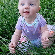 Ember joined the competition — help win amazing prizes! baby, child, grass, outdoor, nature, toddler, blue_eyes, pastel_clothing, sitting, curious, cute, infant, greenery, exploring, young_child, summer, playful, portrait, casual_clothing, daylight