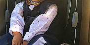 Nicholas is registered to the contest to win money with this photo: child, toddler, car_seat, smiling, happy, clothing, bow_tie, vest, shirt, polka_dot, seat_belt, car_interior, young_child, person, cute, fashion, portrait, baby, kid, sitting