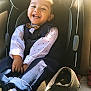 baby, bow_tie, car_interior, car_seat, child, clothing, cute, fashion, happy, kid, person, polka_dot, portrait, seat_belt, shirt, sitting, smiling, toddler, vest, young_child
