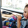 boy, car_interior, car_seat, casual, child, clothing, cute, daylight, fun, happy, kid, portrait, safety, seat, seatbelt, smiling, spiderman, travel, window, young