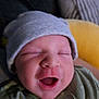 Nico is registered to the contest to win money with this photo: baby, newborn, infant, hat, clothing, smiling, face, mouth_open, sleepy, cozy, closeup, child, cute, soft, portrait, indoors, cushion, yellow, green, happy