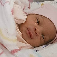 Brittley is registered to the contest to win money with this photo: newborn, baby, infant, child, face, eyes, nose, mouth, pink_hat, blanket, swaddled, sleeping, lying_down, portrait, close_up, indoors, bed, cozy, soft, pastel
