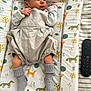 Oakley is registered to the contest to win money with this photo: newborn, baby, sleeping, infant, socks, clothing, changing_pad, animal_pattern, remote_control, bed_sheet, striped, peaceful, cute, indoor, portrait, resting, soft_lighting, small_hands, small_feet, closeup