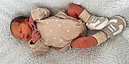 Oakley is registered to the contest to win money with this photo: newborn, baby, sleeping, onesie, socks, shoes, blanket, soft_texture, infant, cute, peaceful, resting, closeup, portrait, clothing, skin, head, hand, footwear, cozy
