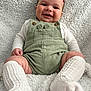 baby, smiling, romper, white_socks, knitted_socks, blanket, soft_texture, infant, cute, happy, portrait, child, cozy, cuddly, sitting, indoor, warm, comfortable, cute_face, button_details