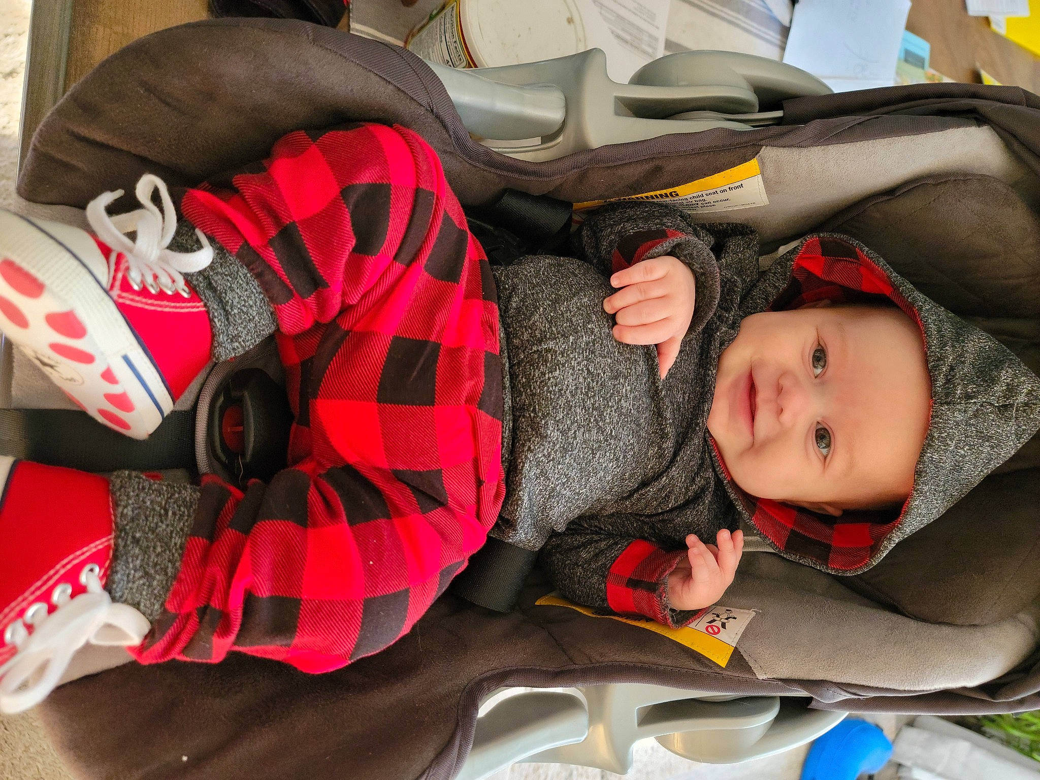 Westen is registered to the contest to win money with this photo: baby, baby_carriage, baby_products, bag, car_seat, carmine, child, comfort, fictional_character, headgear, headwear, joy, linens, mouth, pattern, person, personal_protective_equipment, plaid, red, sitting