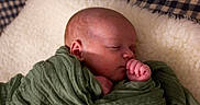 Liam joined the competition — help win amazing prizes! baby, blanket, child, closeup, cozy, cute, face, green, hands, head, indoor, infant, newborn, peaceful, portrait, resting, sleeping, soft, texture, wrapped