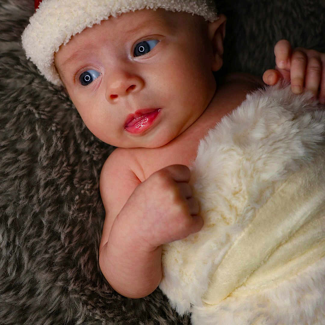 Harper joined the competition — help win amazing prizes! baby, beanie, blanket, bodypart, bonnet, cap, clothing, face, finger, hand, happy, hat, head, newborn, person, photography, portrait, smile
