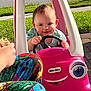 Violet joined the competition — help win amazing prizes! baby, child, clothing, colorful, food, grass, hand, happy, outdoor, person, pink, plastic, play, sandwich, sidewalk, smile, steering_wheel, sunlight, toy_car, vehicle