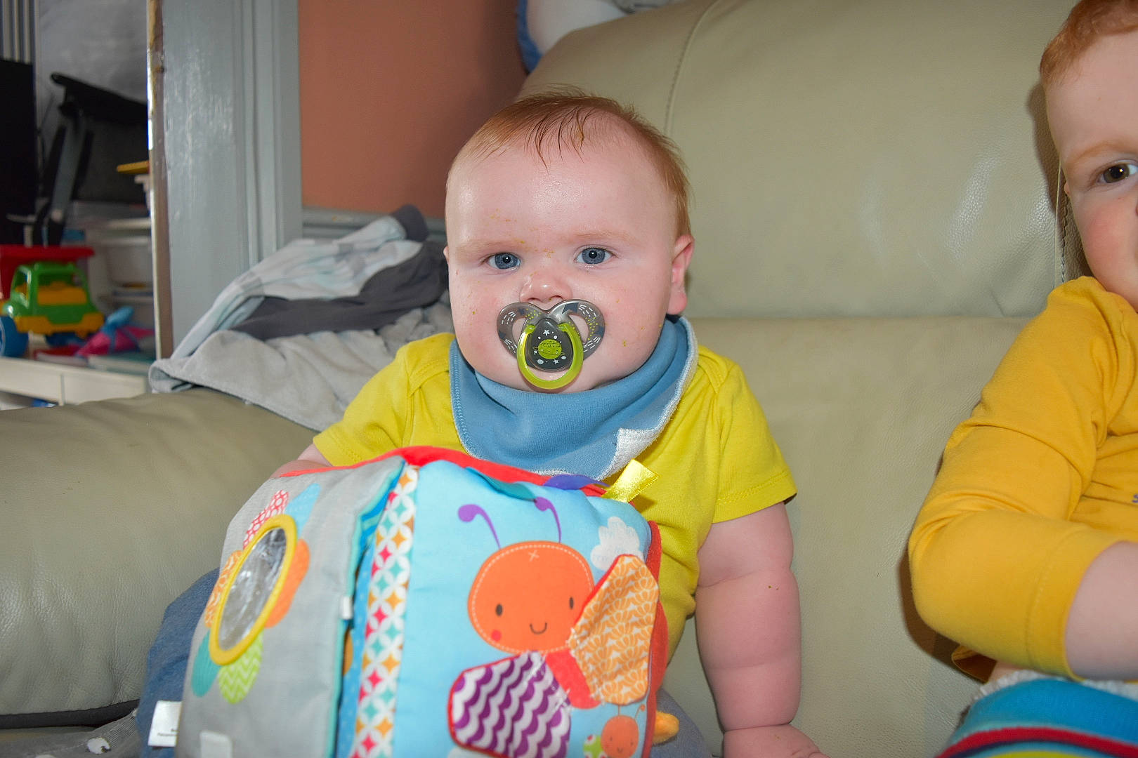 Tyler is registered to the contest to win money with this photo: baby, baby_products, baby_toddler_clothing, baby_toys, cheek, child, comfort, eye, fun, happy, humour, iris, mouth, nose, person, room, sitting, skin, sleeve, t_shirt