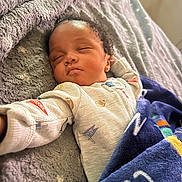 Enzo is registered to the contest to win money with this photo: baby, bed, blanket, child, clothing, comfort, cozy, cute, face, head, indoor, infant, peaceful, portrait, reaching_arm, relaxation, resting, sleeping, soft_texture, warm