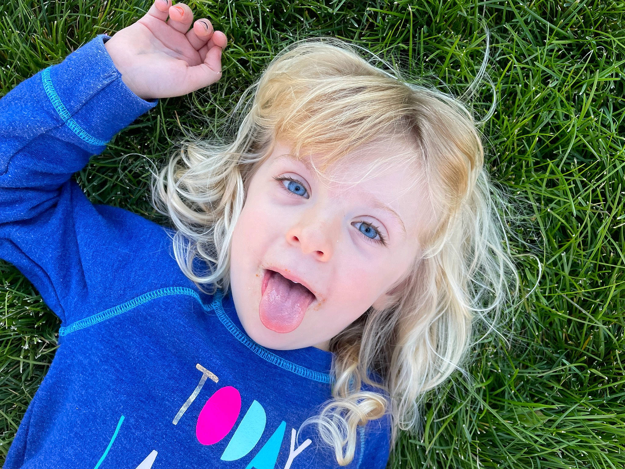 Channing is registered to the contest to win money with this photo: baby_toddler_clothing, blond, cheek, child, electric_blue, finger, fun, gesture, grass, happy, lawn, leisure, lip, nose, people_in_nature, person, plant, skin, smile, summer