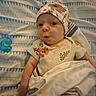 River joined the competition — help win amazing prizes! baby, infant, child, portrait, lying_down, blanket, pajamas, head_covering, floral_pattern, pacifier, bed, bedding, face, eyes, expression, indoor, cozy, photography, cute, soft_lighting