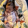 Milanie is registered to the contest to win money with this photo: baby, sleeping, blanket, patterned_blanket, onesie, hair_clips, infant, cozy, soft_lighting, cute, child, indoors, resting, peaceful, comfortable, pajamas, footie_pajamas, close_up, portrait, adorable