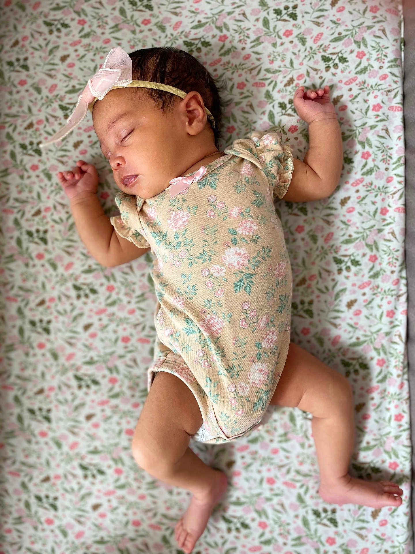 Milanie joined the competition — help win amazing prizes! baby, sleeping, infant, floral, onesie, headband, pink_bow, blanket, pattern, soft, cute, peaceful, skin, limbs, lying_down, indoors, child, newborn, resting, adorable