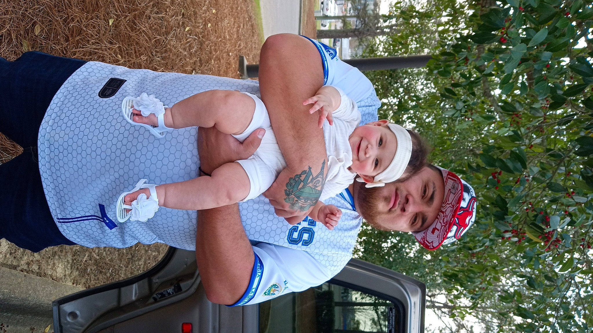 Estrella is registered to the contest to win money with this photo: arm, baby, chest, child, elbow, event, fun, happy, hat, headwear, human_leg, joy, knee, leisure, person, recreation, shorts, smile, t_shirt, thigh