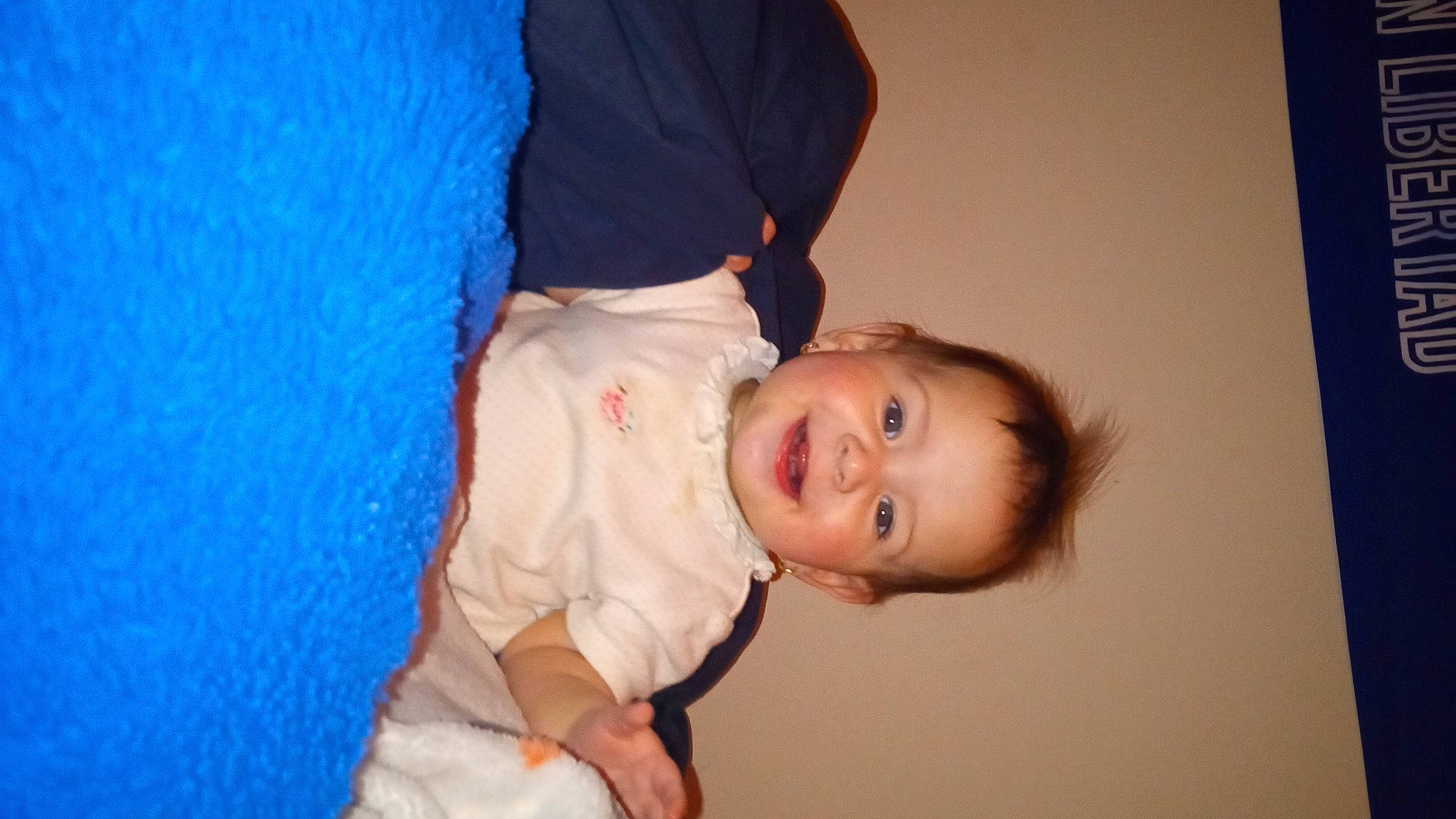 Estrella is registered to the contest to win money with this photo: baby, baby_toddler_clothing, cheek, child, comfort, elbow, electric_blue, flash_photography, fun, gesture, happy, joy, nose, person, room, sitting, sleeve, smile, toddler, wood