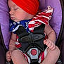 Hailey joined the competition — help win amazing prizes! baby, sleeping, car_seat, headband, red, blue, white, stripes, stars, infant, clothing, safety_harness, bracelet, barefoot, peaceful, child, cute, portrait, indoor, colorful