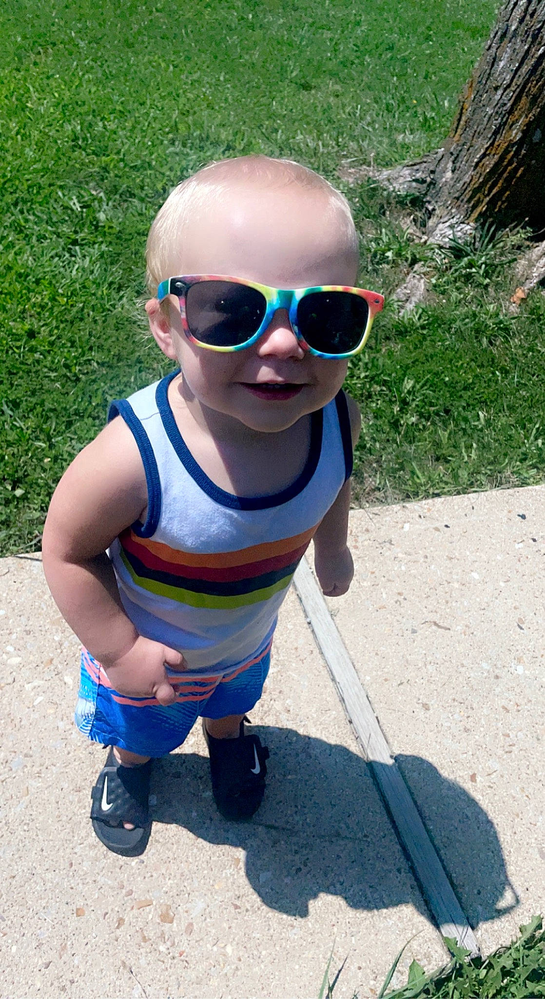 Josiah is registered to the contest to win money with this photo: azure, baby, baby_toddler_clothing, blue, child, cool, electric_blue, eyewear, fun, glasses, goggles, grass, head, leisure, person, personal_protective_equipment, plant, summer, sunglasses, toddler