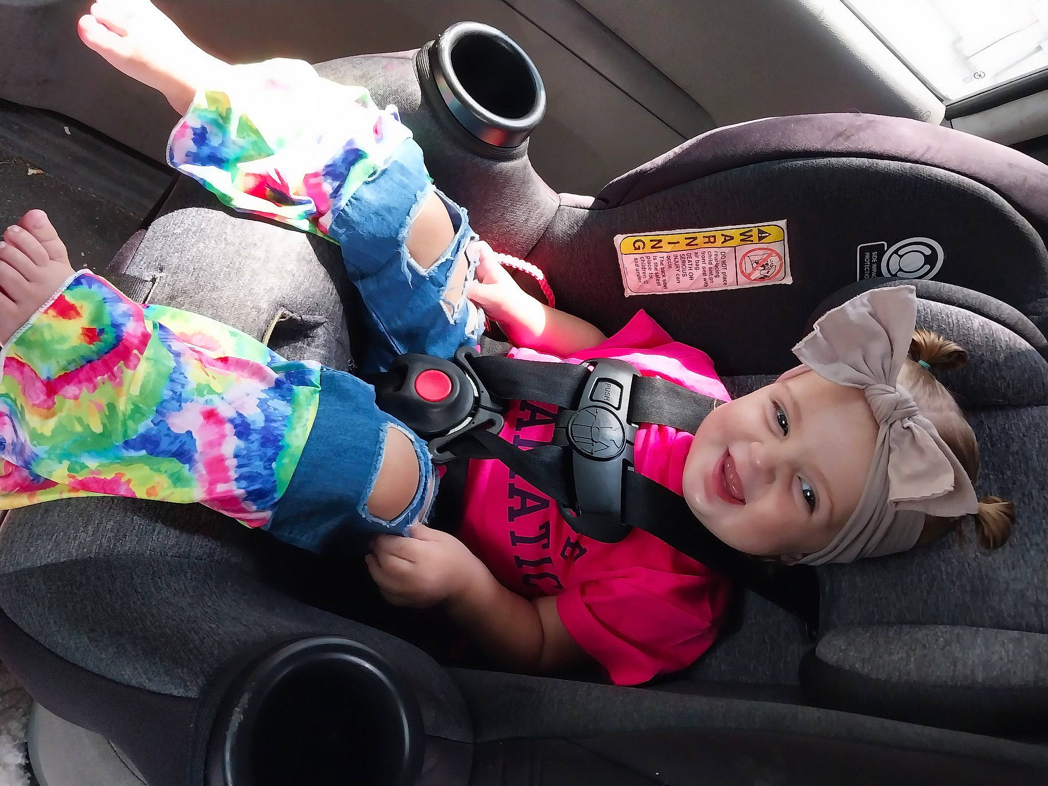 Khloe joined the competition — help win amazing prizes! auto_part, automotive_design, automotive_exterior, car_seat, car_seat_cover, carmine, child, comfort, family_car, head_restraint, headwear, human_leg, joy, lap, motor_vehicle, person, personal_protective_equipment, smile, steering_wheel, thigh