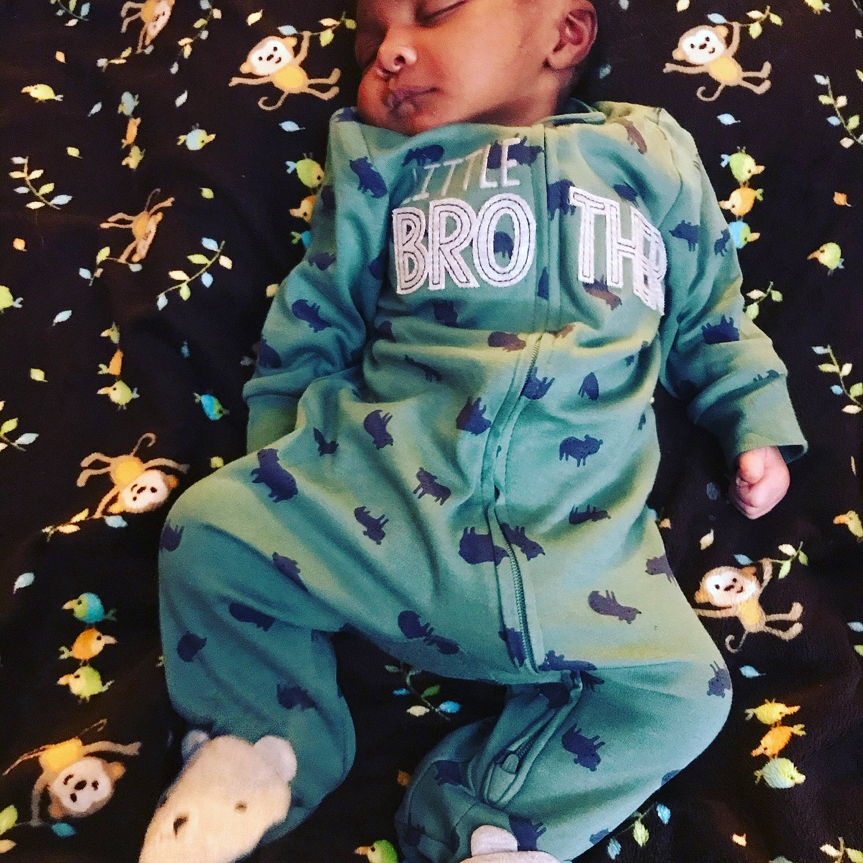 Armoni is registered to the contest to win money with this photo: baby, baby_toddler_clothing, button, camouflage, human_body, military_camouflage, nightwear, overall, pajamas, pattern, person, sleeve