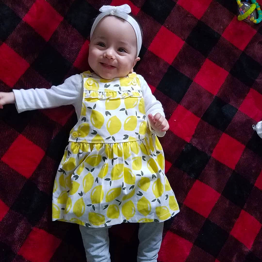 Magnolia is registered to the contest to win money with this photo: baby, baby_toddler_clothing, child, clothing, design, dress, joy, outerwear, pattern, person, plaid, polka_dot, sleeve, smile, textile, toddler, yellow
