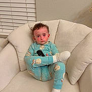 Adam joined the competition — help win amazing prizes! armchair, casual, child, cozy, curly_hair, face, home, indoor, neutral_wall, pajamas, person, plush_furniture, relaxing, remote_control, rosy_cheeks, seated, serious_expression, socks, toddler, window_blinds