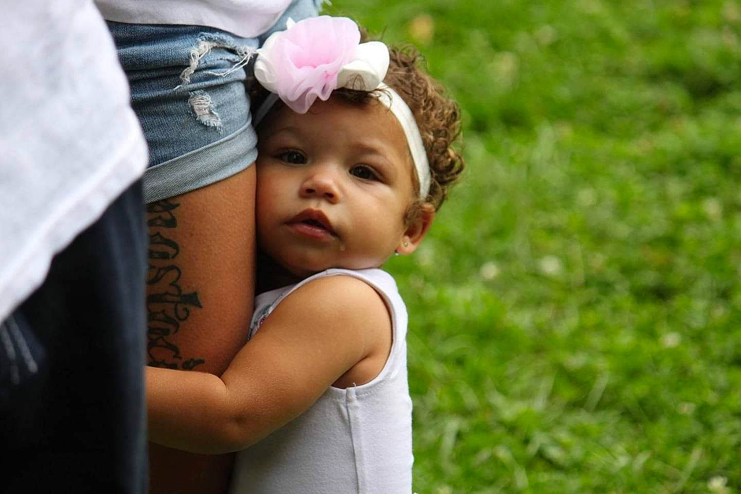 Story Liana is registered to the contest to win money with this photo: child, flower, fun, girl, grass, hair_accessory, happiness, headgear, headpiece, infant, person, plant, smile, toddler