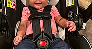 Avery joined the competition — help win amazing prizes! baby, blue_pants, car_seat, child, closeup, curly_hair, cute, feet, foot, happy, head_support, indoors, infant, person, pink_shirt, portrait, safety_harness, seatbelt, smiling, young_child