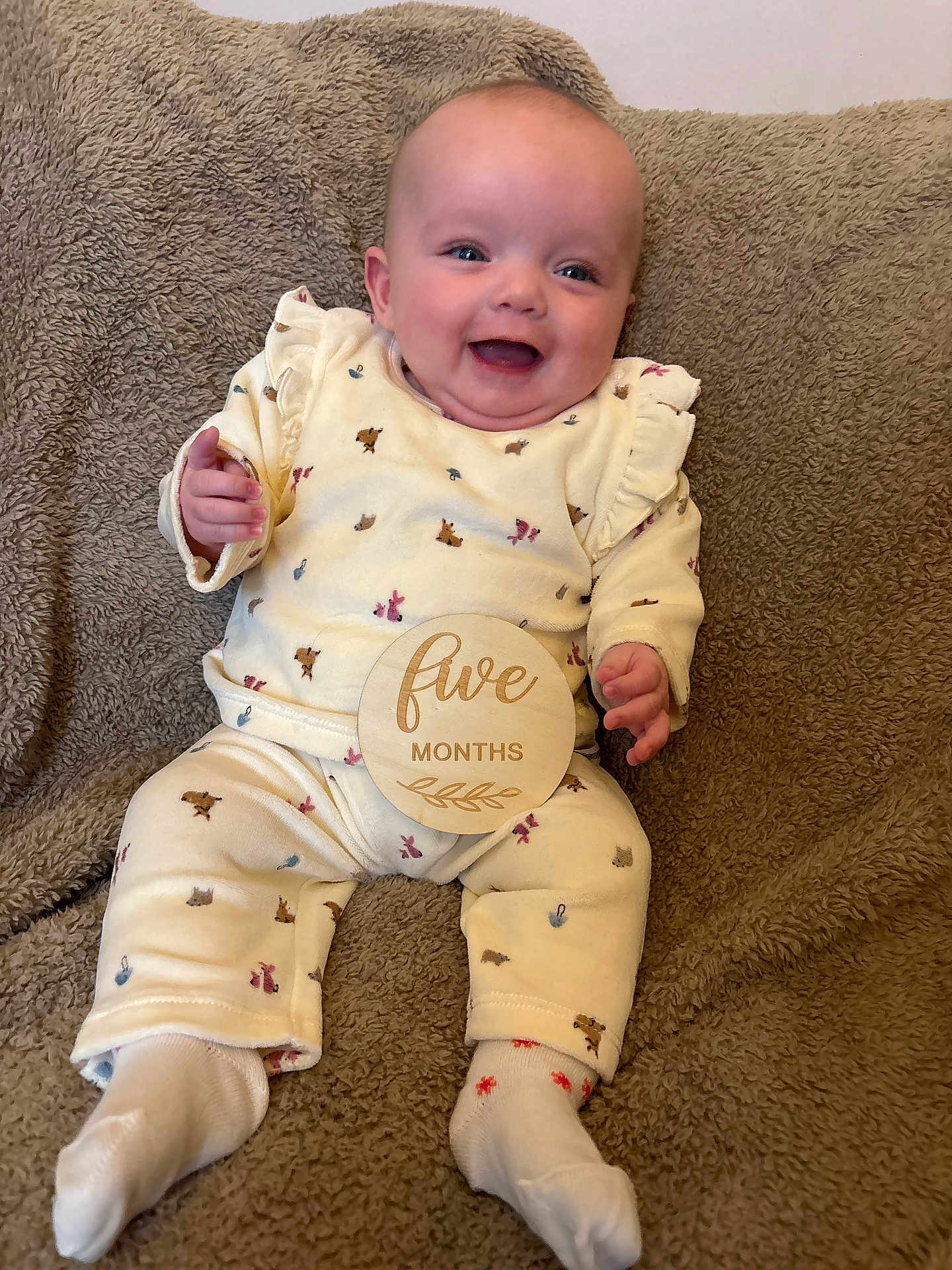 Emmie joined the competition — help win amazing prizes! baby, infant, smiling, happy, five_months, wooden_sign, plush_blanket, sitting, clothing, onesie, socks, cute, child, portrait, indoors, young_child, face, head, hand, feet