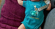 Antonio is registered to the contest to win money with this photo: baby, blanket, blue_outfit, burgundy_blanket, child, close_up, couch, indoors, infant, lying_down, mittens, onesie, pacifier, pacifier_clip, peaceful, portrait, relaxed, sitting, sleeping, text_on_clothing