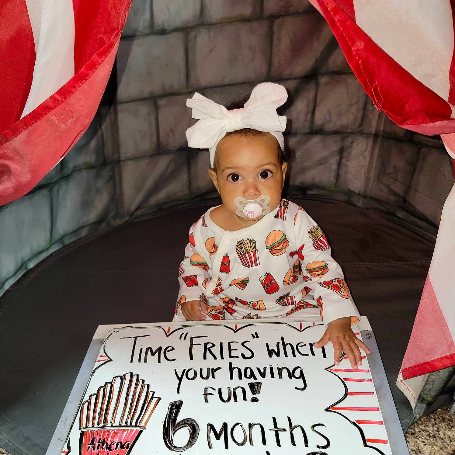 Athena is registered to the contest to win money with this photo: baby, baby_toddler_clothing, birthday_party, cake, cake_decorating_supply, child, costume_hat, design, event, font, happy, icing, mammal, party_supply, person, pink, sleeve, sugar_cake, textile, toddler