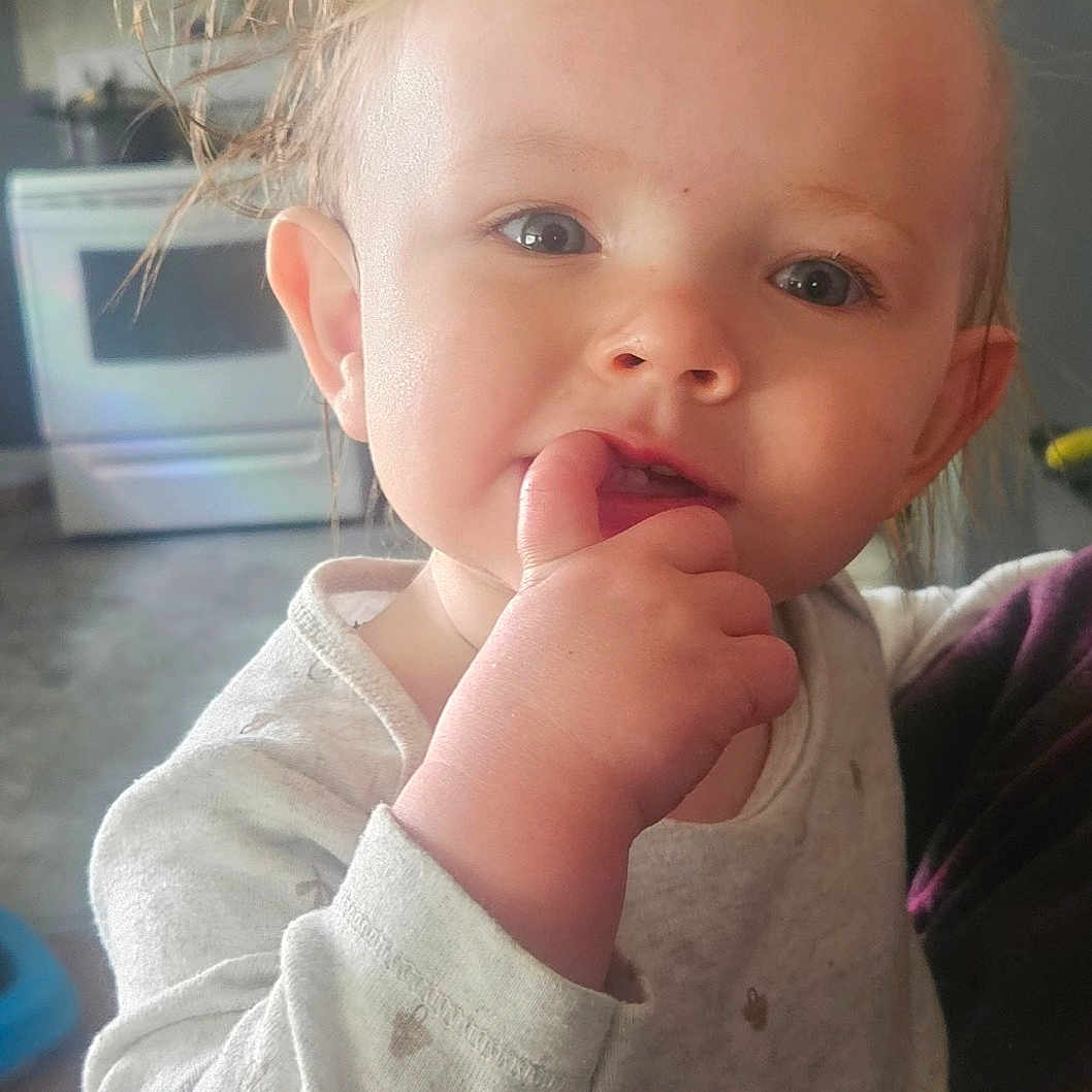 Oliver is registered to the contest to win money with this photo: baby, background, child, clothing, curious, cute, expression, face, hair, hand, home, indoor, kitchen, light, long_sleeve, person, portrait, skin, toddler, young_child