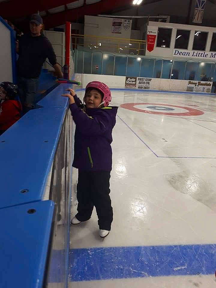 Kiley is registered to the contest to win money with this photo: building, fun, headwear, ice, ice_rink, ice_skate, ice_skating, leisure, person, recreation, skating, snow, sports_equipment, under_exposed, winter, winter_sport