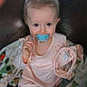 Delta joined the competition — help win amazing prizes! baby, blanket, child, comfort, cozy, cute, expression, face, hands, hat, home, indoors, infant, pacifier, pink_clothing, portrait, seated, soft_toys, warm, young_child
