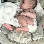 Delta is registered to the contest to win money with this photo: baby, infant, plush_toy, lion_toy, blanket, baby_seat, cushion, diaper, indoor, wood_floor, baby_gaze, cute, soft_toy, child, home, baby_boy, baby_girl, sleepy, comfort, cozy