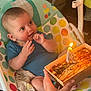 baby, birthday, candle, cake, highchair, indoor, child, polka_dot, seat, hand, colorful, smiling, cute, person, celebration, food, table, happy, clothing, face