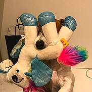 Iona participe au concours pour gagner de l'argent avec cette photo : animal, brown, claw, colorful, cute, dog, fabric, fun, furry, home, indoor, nose, paw, pet, playful, plush, stuffed_animal, toy, unicorn, white