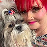 Bode Max is registered to the contest to win money with this photo: woman, dog, pet, red_hair, makeup, bow, indoor, portrait, face, closeup, affection, smile, colorful, patterned_clothing, long_hair, cute, animal, cozy, friendship, holiday