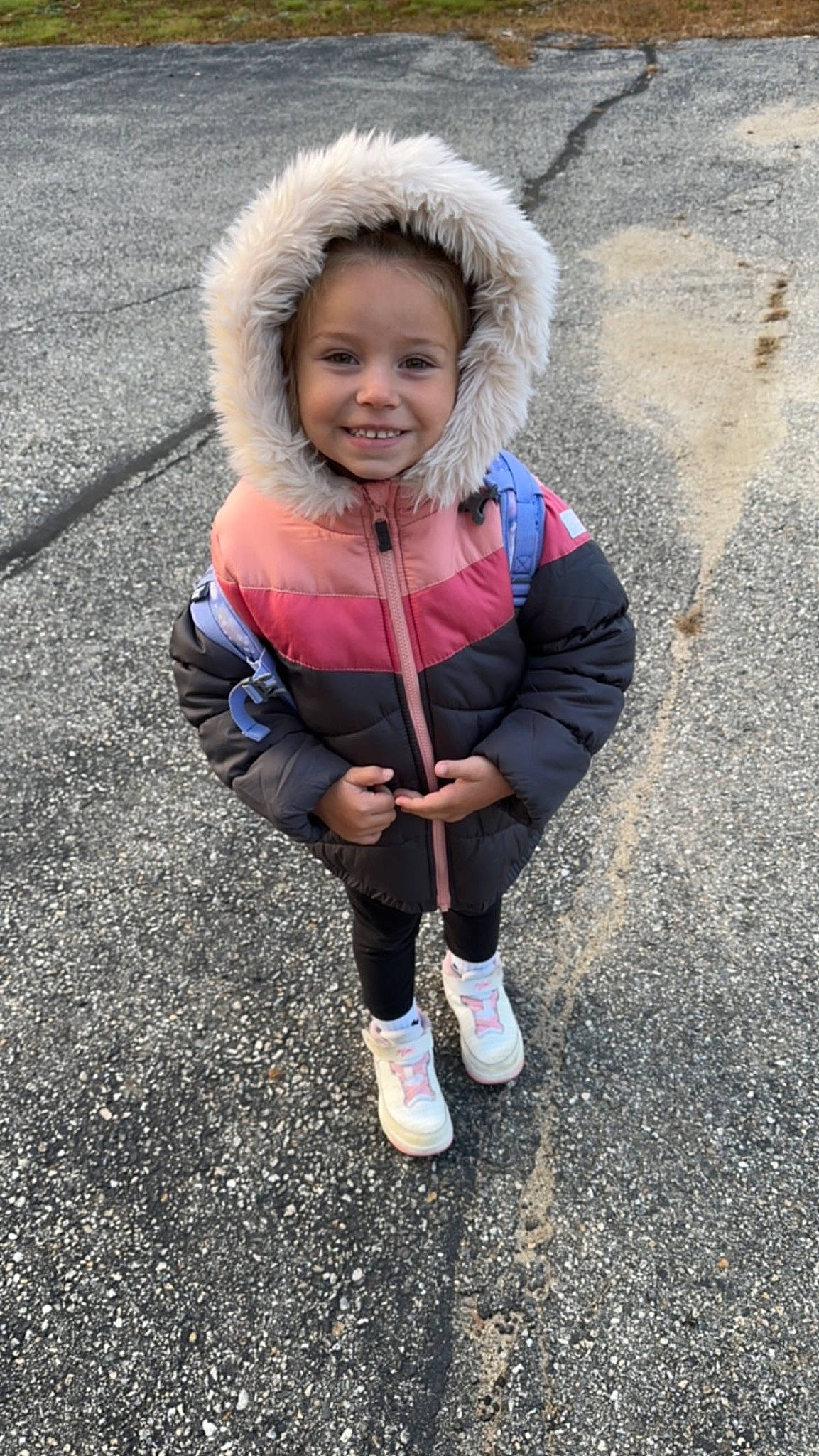 Brynnleigh is registered to the contest to win money with this photo: asphalt, child, electric_blue, eye, face, fashion_accessory, fun, fur, grass, happy, joy, leisure, person, plant, recreation, road_surface, sitting, smile, sneakers, soil