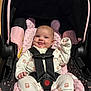 Kinsley joined the competition — help win amazing prizes! baby, black, car_seat, child, clothing, comfort, cute, face, happy, indoors, infant, newborn, patterned_clothing, person, pink, plush, safety_harness, seat, seat_belt, smile