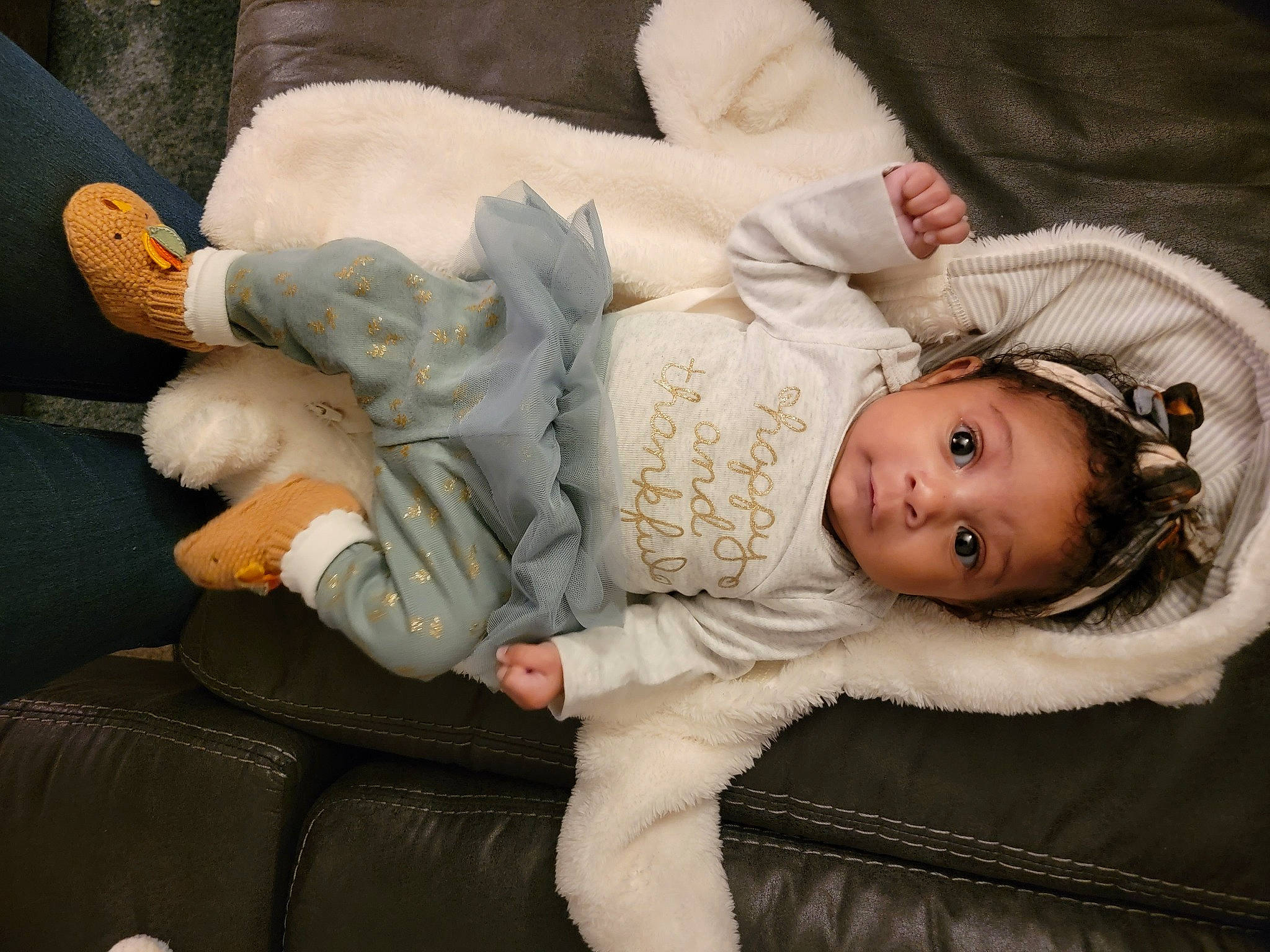 Arianna is registered to the contest to win money with this photo: baby, baby_products, baby_toddler_clothing, blond, cheek, child, comfort, flash_photography, fur, human_leg, lap, leg, person, portrait_photography, sitting, skin, thigh, toddler, wood
