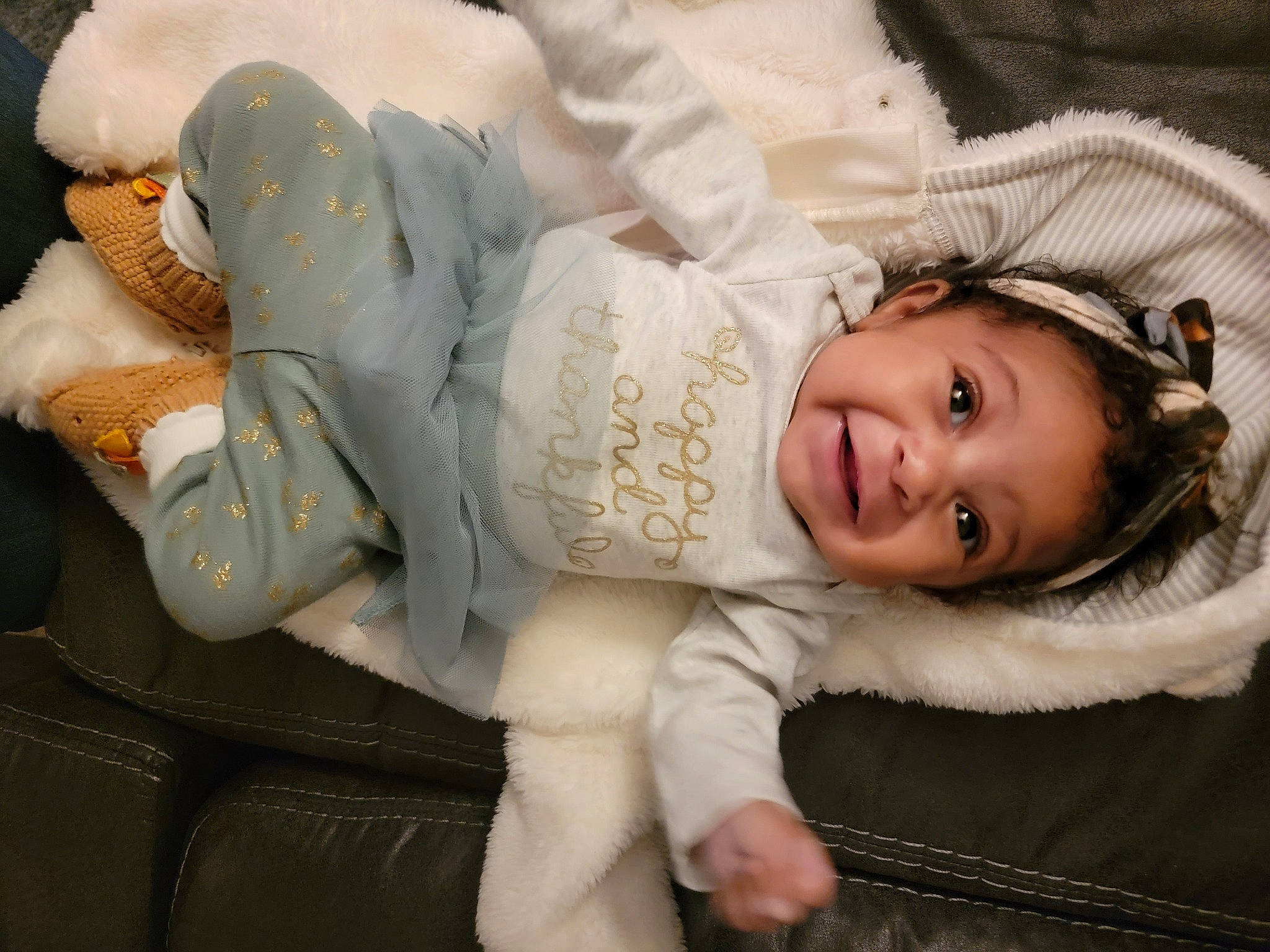 Arianna is registered to the contest to win money with this photo: cheek, child, comfort, fashion_accessory, flash_photography, fur, happy, hat, headgear, human_body, human_leg, joy, lap, leg, mouth, person, sitting, skin, smile, textile