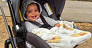Zaedyn is registered to the contest to win money with this photo: baby, stroller, blanket, hoodie, smile, child, outdoor, park, trees, greenery, infant, seatbelt, happy, person, nature, grass, daylight, cute, cozy, photography