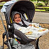 baby, stroller, blanket, hoodie, smile, child, outdoor, park, trees, greenery, infant, seatbelt, happy, person, nature, grass, daylight, cute, cozy, photography