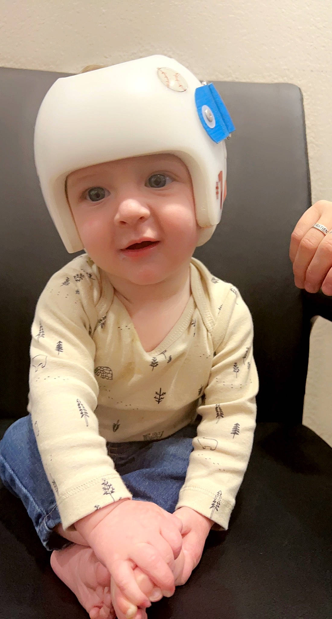 Kohen is registered to the contest to win money with this photo: baby, baby_safety, baby_toddler_clothing, cap, cheek, child, comfort, finger, flooring, fun, happy, headgear, headwear, person, personal_protective_equipment, pink, sitting, skin, sleeve, smile