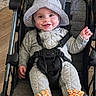 Atlas joined the competition — help win amazing prizes! baby, smiling, stroller, hat, quilted_clothing, footwear, giraffe_booties, child, happy, indoor, seatbelt, gray, orange, person, infant, cute, portrait, headwear, clothing, sitting