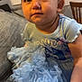 Katherine is registered to the contest to win money with this photo: toddler, child, blue_dress, frills, sitting, couch, indoor, curious, face, hands, furniture, wooden_chair, clothing, cute, portrait, young_child, expression, soft_light, home, baby